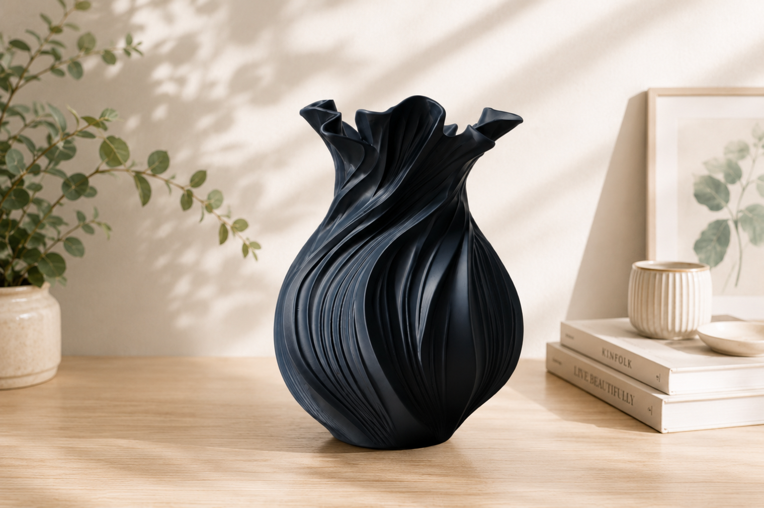 Black Wave Vase 3D printed on a wooden desk beside books for tidy room organization