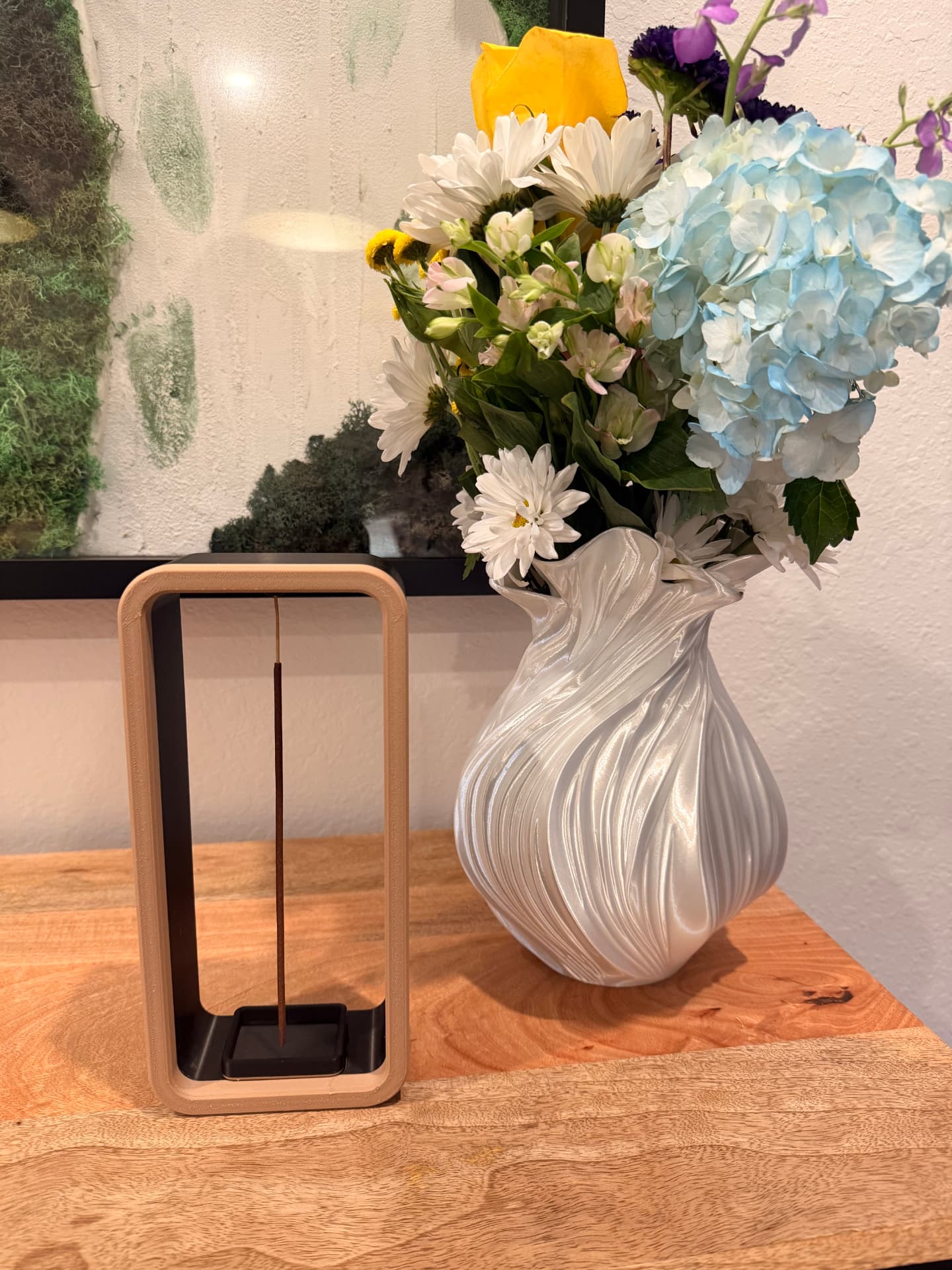 Close-up detail of the white Wave Vase next to minimal home decor accessories