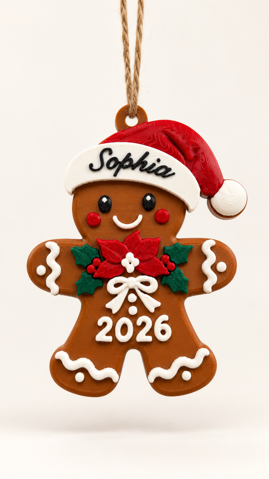 Personalized gingerbread man Christmas ornament with red Santa hat, custom name and 2026 detail on a cream background